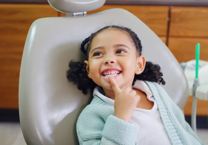 Smiling patient reclined in a dental chair